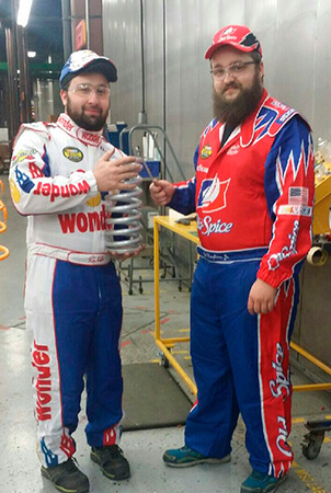 Two Landscape Structures employees pose for the camera while dressed like the characters of the popular movie Talladega Nights.