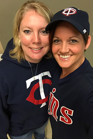 Landscape Structures Megan and Allison smile for the camera while where Twins baseball attire.