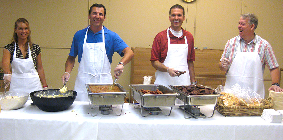 Landscape Structures employees serving food.